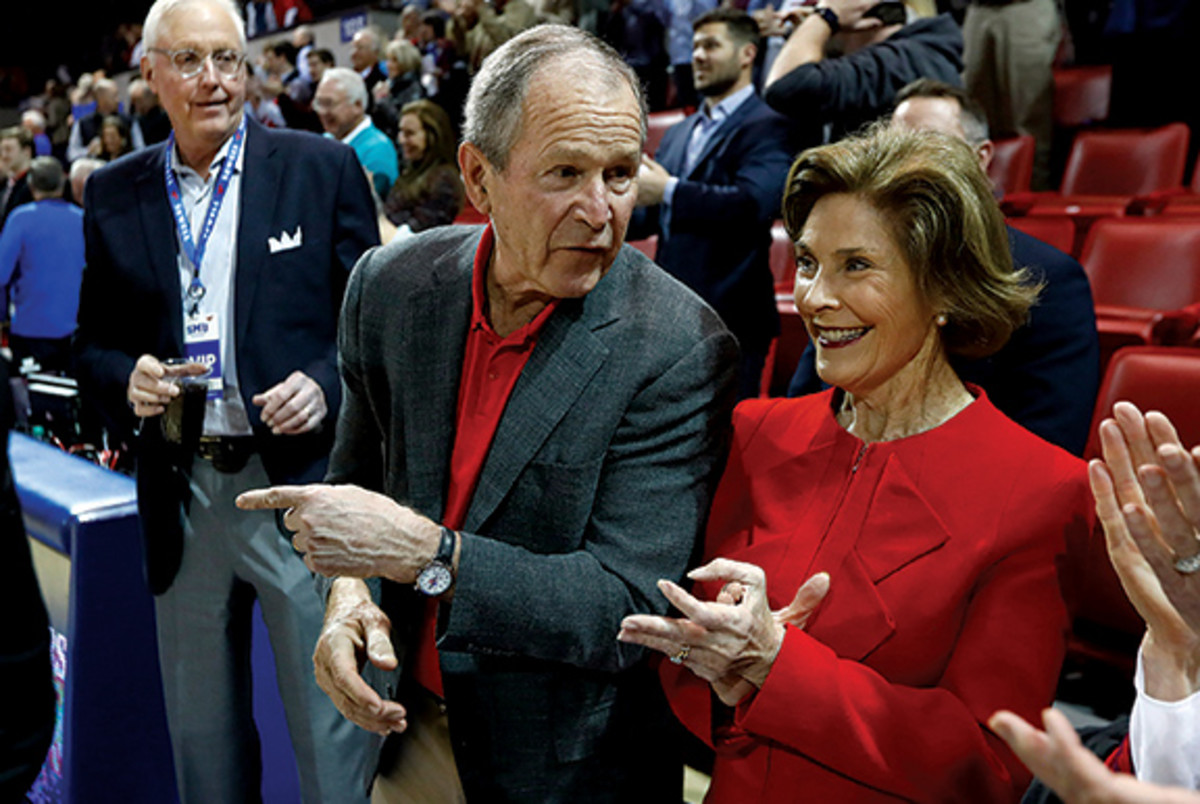 President George W. Bush watches from the sidelines as the Memphis Tigers take on the SMU Mustangs at the Moody Coliseum on Tuesday, Feb. 25, 2020.